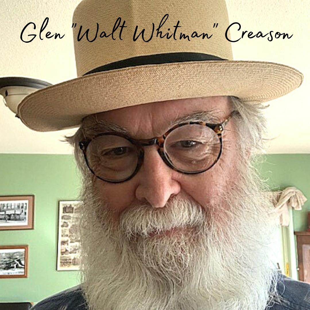 Glen strikes a pose in a beard, hat, and glasses, looking very much the proper poet.
