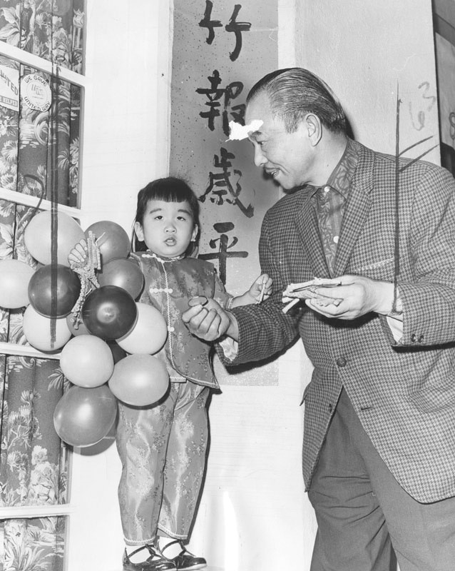 Eugene Yee and niece Susan celebrate Chinese New Year with balloons and firecrackers.
