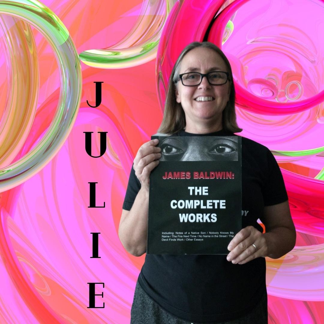 Julie holds a book in front of a swirling pink background, representing her effervescent personality and love of reading.