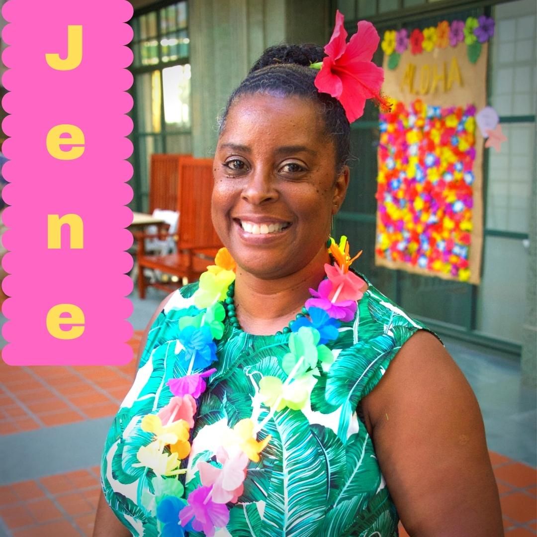 Jene looks radiant in a tropical dress with a red flower tucked into her hair.