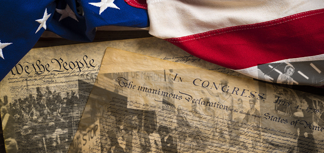 Declaration of Independence with American flag draped on upper edge of image