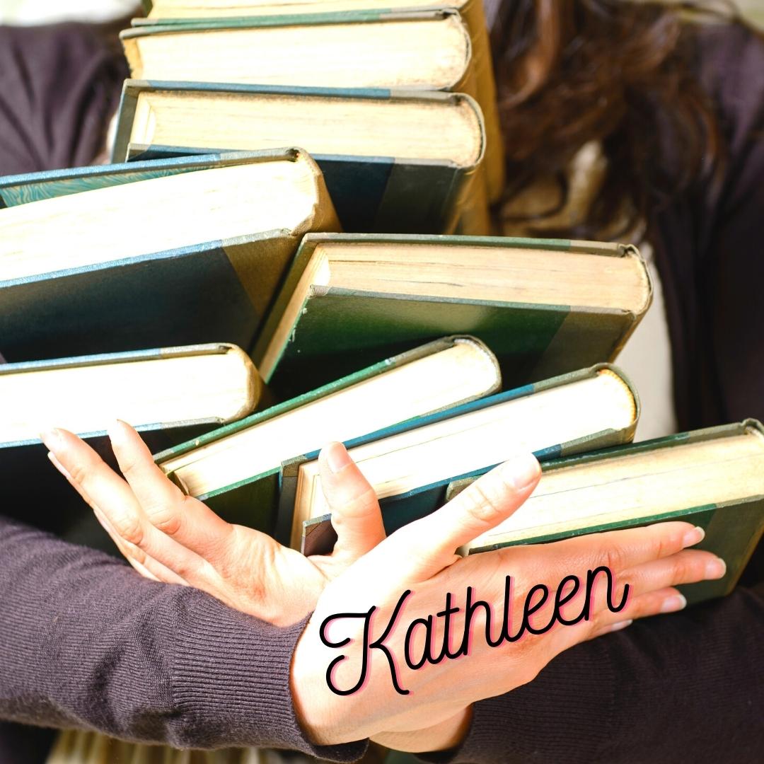 Kathleen holds an armful of books because she loves to read.
