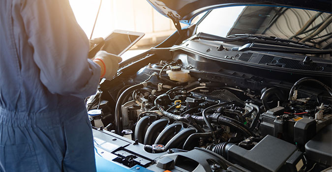Close up of the mechanic is checking the car condition in the car service center.