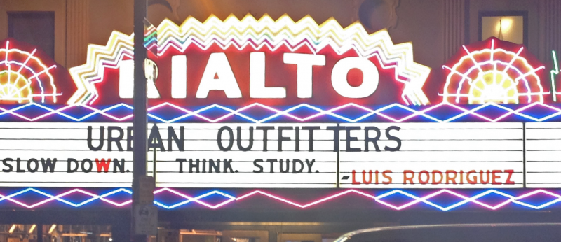 Rialto Theatre Marquee reads: "Slow down. Think. Study. —Luis Rodriguez"