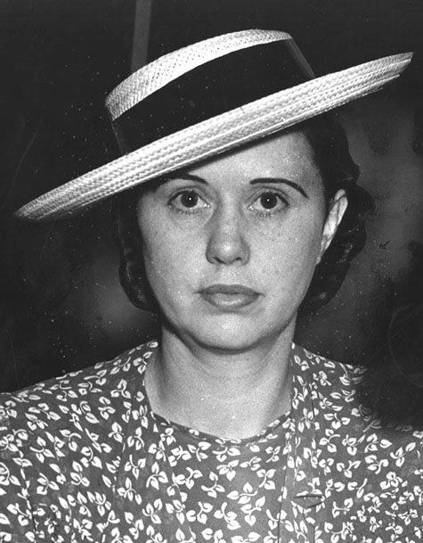 Ann Forst wearing a hat and floral dress