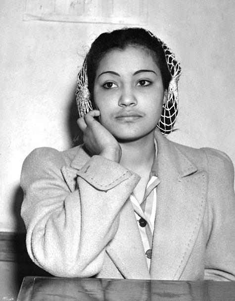 Photograph shows a young woman identified as Lupe Brooks