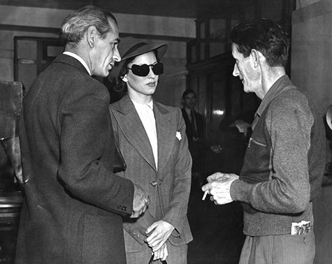 a woman identified as Donna Steward flanked by attorneys Wyman Reynolds and Charles R. Hopper