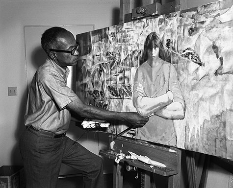 Artist Charles White painting at home