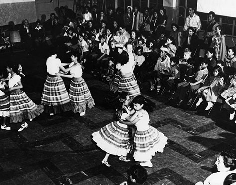 Girls in Mexican costumes perform a dance at a Cinco de Mayo celebration at the William Mead Homes Housing Project. 