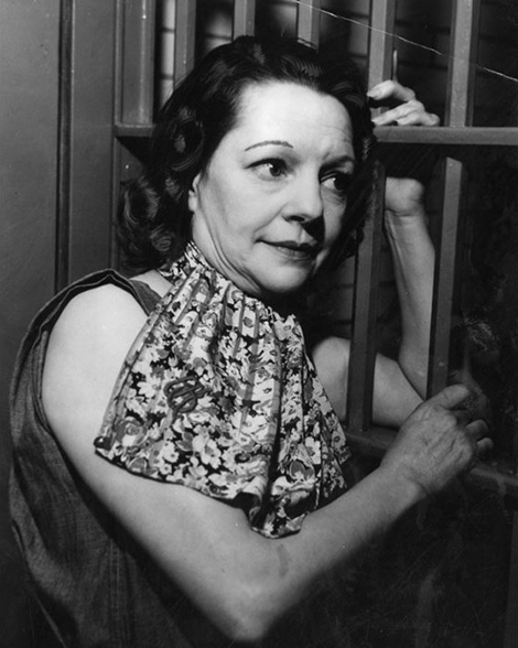 Hazel Glab poses next to the bars in her cell at the Hall of Justice Jail. 
