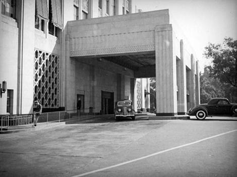 Showing a car leaving the porte-cochere and rear entrance of Bullocks Wilshire