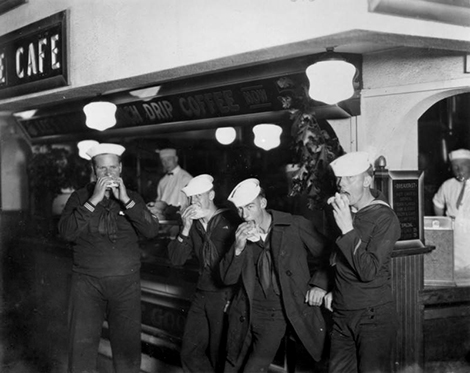 Sailors on shore leave enjoy a meal at a café