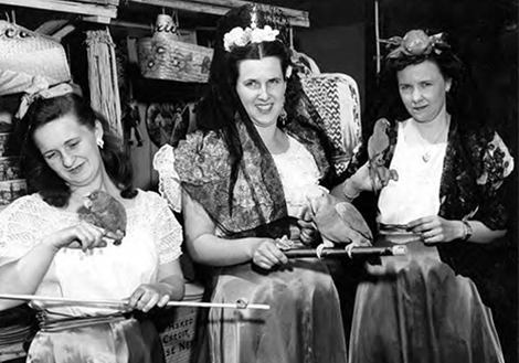 Three women with parakeets