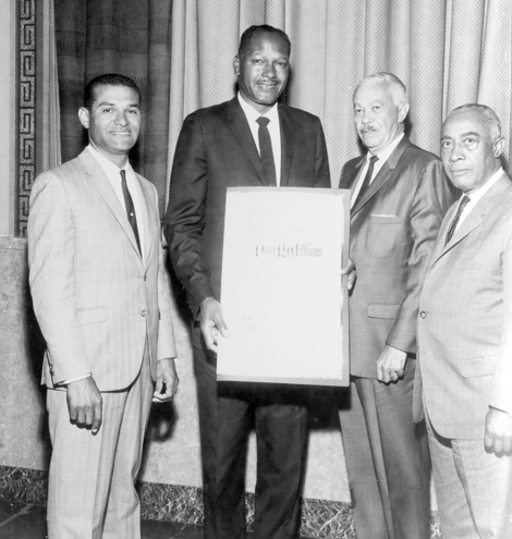 Paul R. Williams receiving a resolution from city Councilmen Tom Bradley, Billy Mills, Gilbert Lindsay in 1965