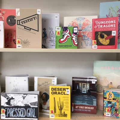 zine collection on a bookshelf