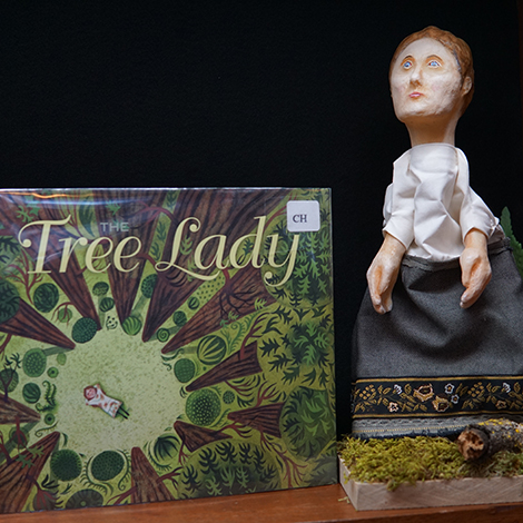 the book The Tree Lady next to a puppet of a character from the book