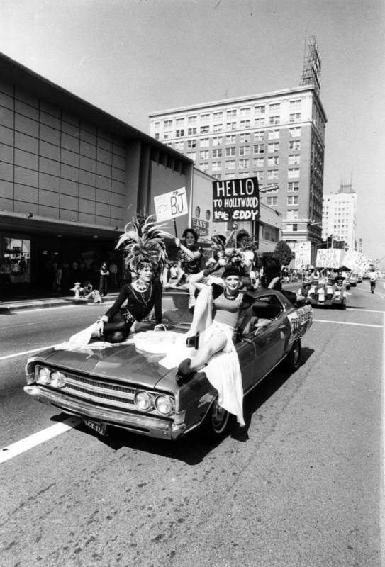  a car load of participants rolls down Hollywood Boulevard