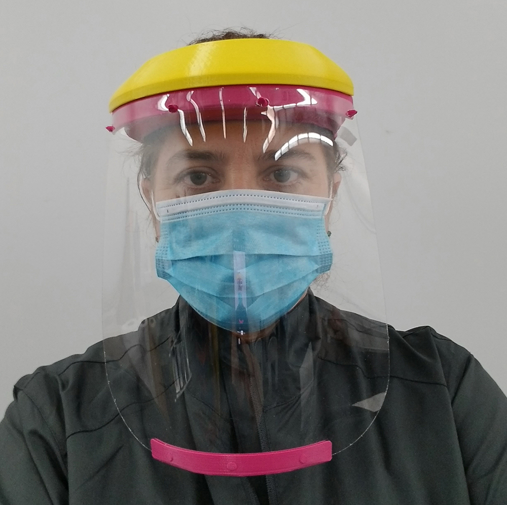 staff member wearing a full face shield
