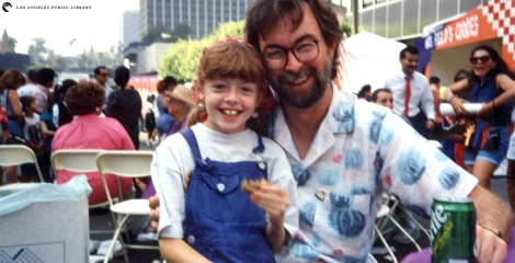 Glen Creason and his daughter celebrate the re-opening of Central Library on a closed-off 5th Street