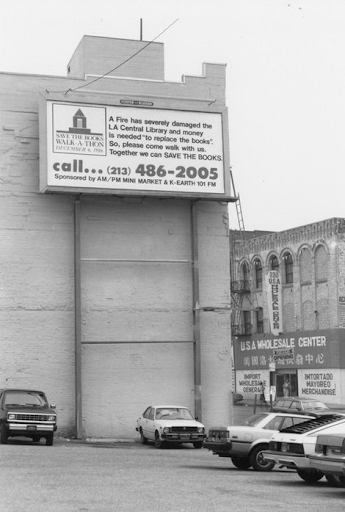 a downtown billboard with a phone number