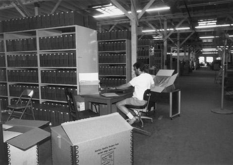 Glen Creason organizes photos from the Herald Examiner newspaper at the Rio Vista warehouse.