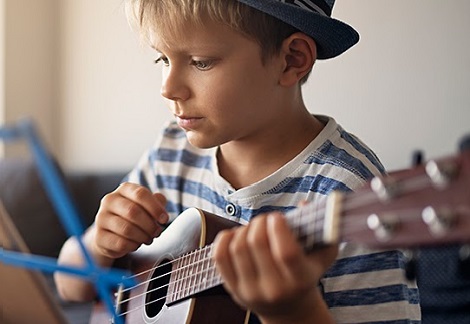 boy playing a guitar