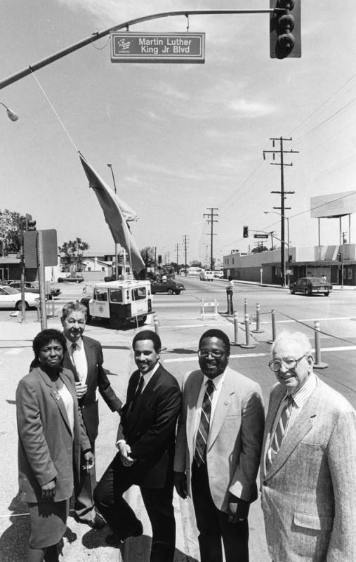 Lynwood city council members under a new MLK blvd sign