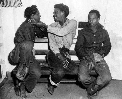 three men in a jail cell