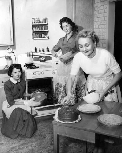3 women cook in a kitchen