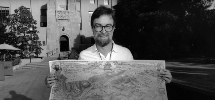 Glen holding a map in front of Central Library