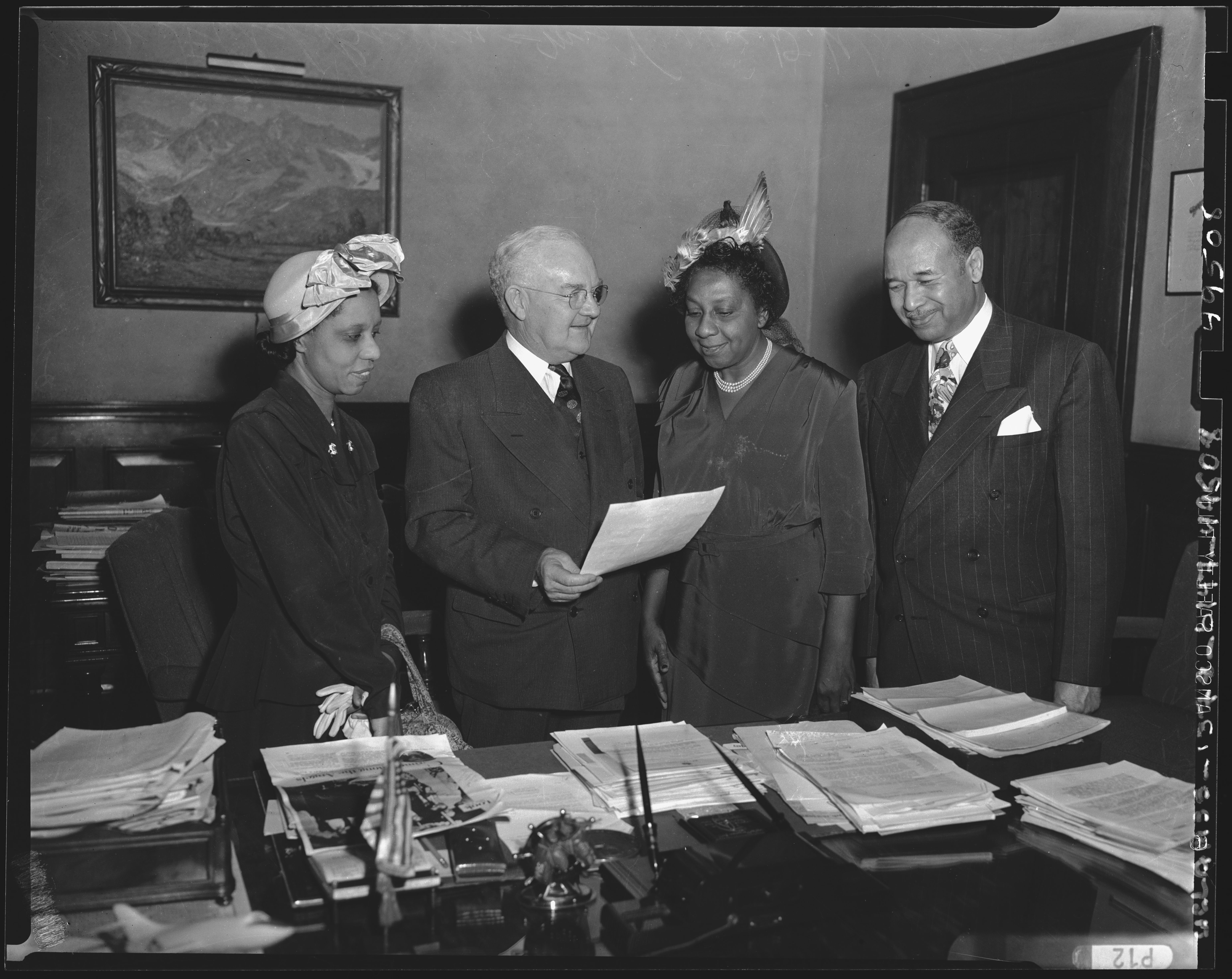 Los Angeles Mayor Fletcher Bowron, in the presence of the Reverend Baxter Duke, Evangeline Woodfolk, and Vassie D. Wright