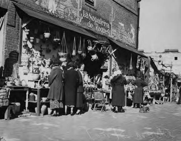 Photograph of ladies outside of booths along Olvera Street