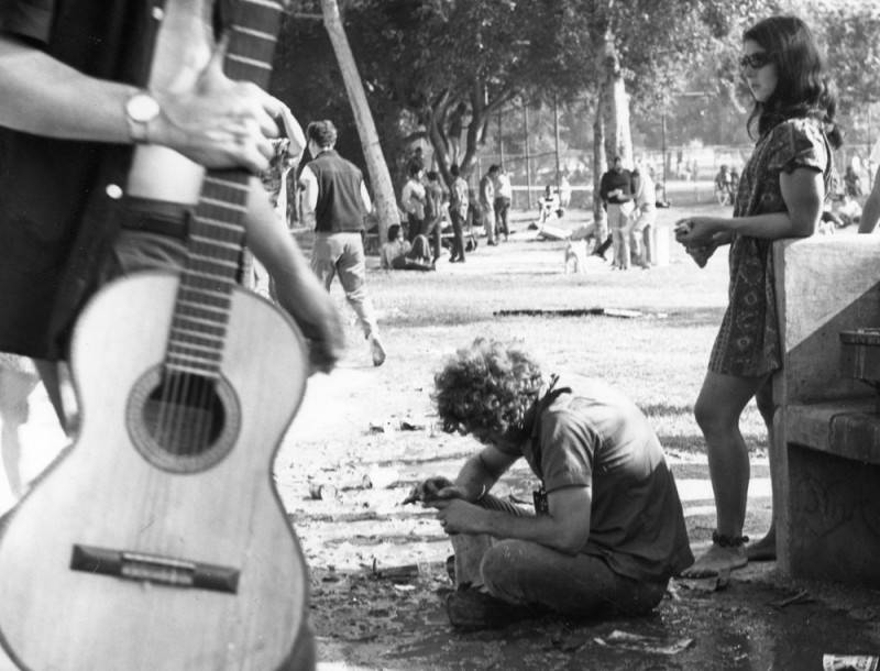 Groups of hippies lounge around a park in Los Angeles.