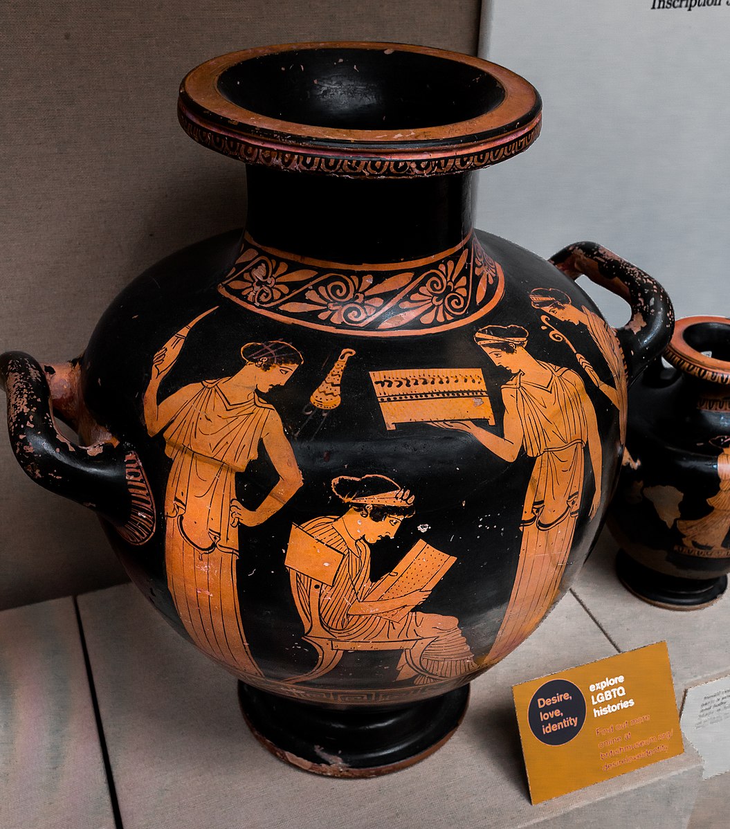 Vase showing a woman reading from a papyrus scroll