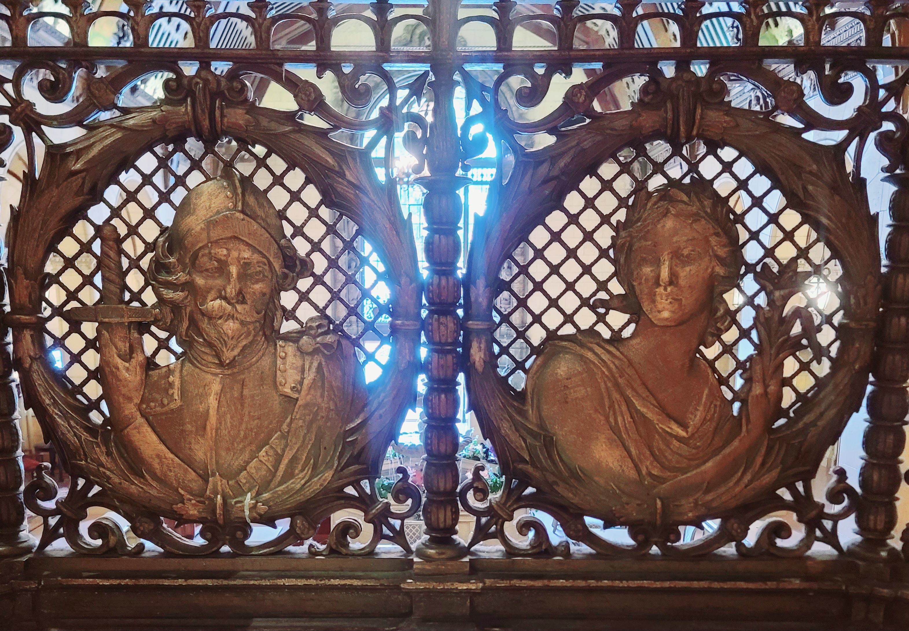 Detail of the bronze reliefs of the Roman goddess Ceres (right) and Spanish Conquistador Vasco Nunez de Balboa (left) at the top of the staircase looking towards the Olive Street entrance
