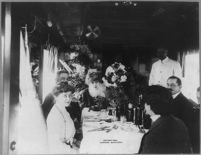Bernhardt and her entourage dining in her train car outside of Dallas, 1906