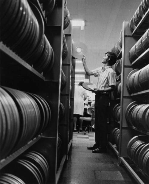 A man retrieving, two reels of film