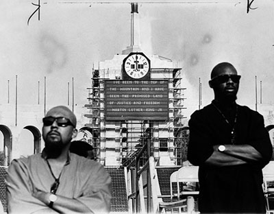 Behind two men, the words of Dr. Martin Luther King, Jr. are flashed on the Coliseum electric board at a memorial service for him on April 7, 1968