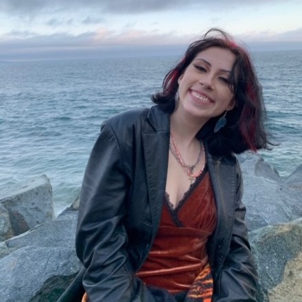 teen volunteer Sophia in front of the ocean at sunset