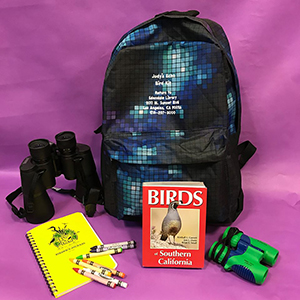 backpack with binoculars and bird book