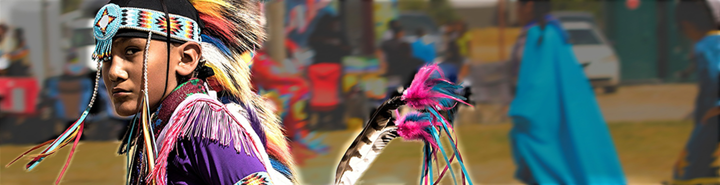 Young American Indian dancing in traditional dress