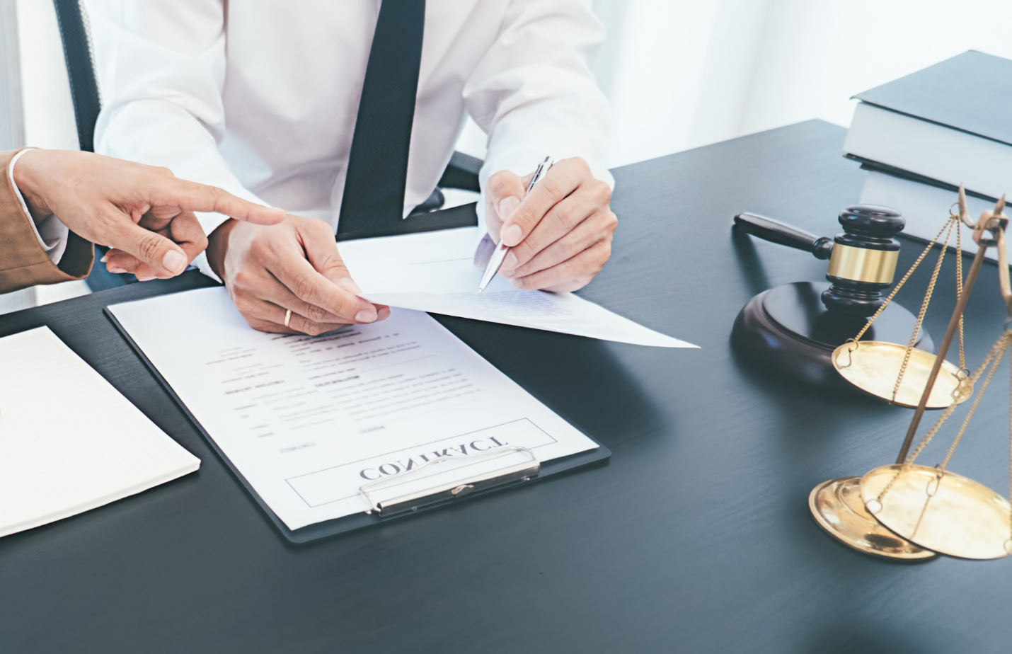 close up of two people's hands going over documents