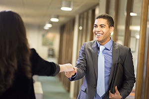 two people shaking hands in business setting