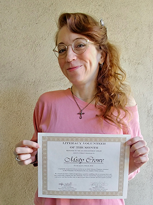 Adult Literacy Volunteer with her award