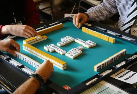 Image of players playing mah jonng