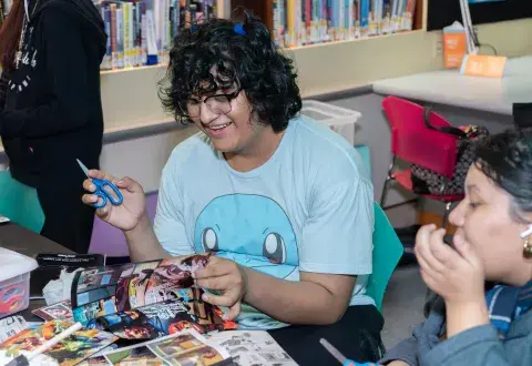 teens doing crafts in a library