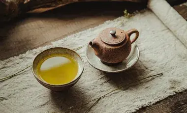 cup of tea and teapot on a table 