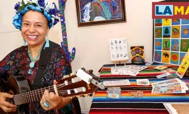 Dr. Gloria Arjona playing a guitar in a colorful room