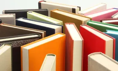 Several books standing on end in a random arrangement.
