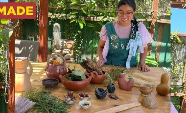 a women displaying clay sculptures